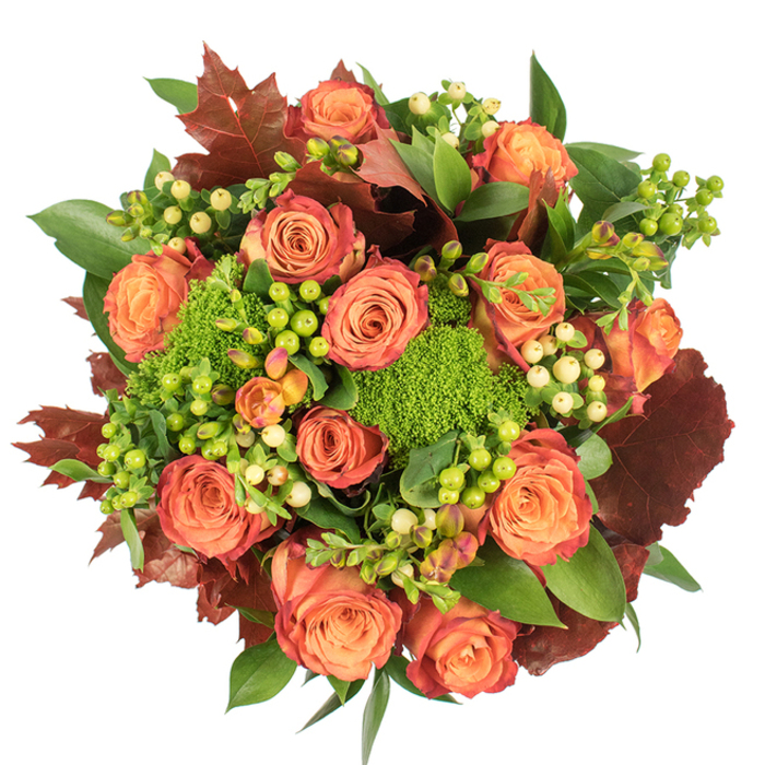 Arranged in a compact, circular formation and photographed from above on a bright white field, this bouquet is an autumn study in colour, texture and careful balance. At its centre, an abundance of full-faced roses command attention: each blossom moves from a warm, soft peach core into brighter coral and then into a richer orange-russet at the outer petals, some edges carrying a hint of reddened rust as leaves do when the air cools. Interspersed with the roses are sprigs of Green Trick dianthus - vivid, cushiony, almost avian tufts of green that read like soft moss - providing dense, tactile contrast to the roses' smooth, layered petals. Accents of Hypericum berries punctuate the arrangement, their lime-green spheres and pale cream beads creating delicate points of interest and a pleasing rhythm across the head. Deeply coloured, lobed foliage in tones of burgundy and dark copper is distributed throughout to give the composition weight and seasonality, evoking lanes edged with burnt-maple leaves on a brisk walk from Church Road to the precinct. Fresh, glossy greens fill the spaces and lift the arrangement, ensuring each bloom sits within a living, breathing frame. Under soft, diffused lighting every surface reads clearly - the velvety depth of petals, the satiny sheen of leaves, the matte mossiness of the dianthus - and a subtle scent emerges: rose warmth tempered by green, earthy undertones. Designed to be a striking Thanksgiving centrepiece, a comforting seasonal gift, or a focal point for a mantel or dining table, this bouquet offers the luxurious, down-to-earth charm of late autumn to homes around Upper Norwood.